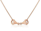 A rose gold snaffle bit necklace with an adjustable chain, presented against a white background.